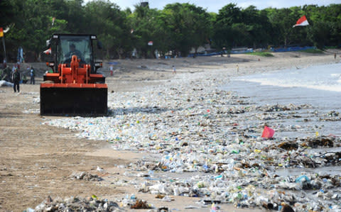 Plastic rubbish on Kuta beach near Denpasar, on Indonesia's tourist island of Bali, triggered an emergency clean-up in December - Credit:  SONNY TUMBELAKA/ AFP