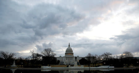 Clouds pass over the U.S. Capitol at the start of the third day of a shut down of the federal government in Washington, U.S., January 22, 2018. REUTERS/Joshua Roberts