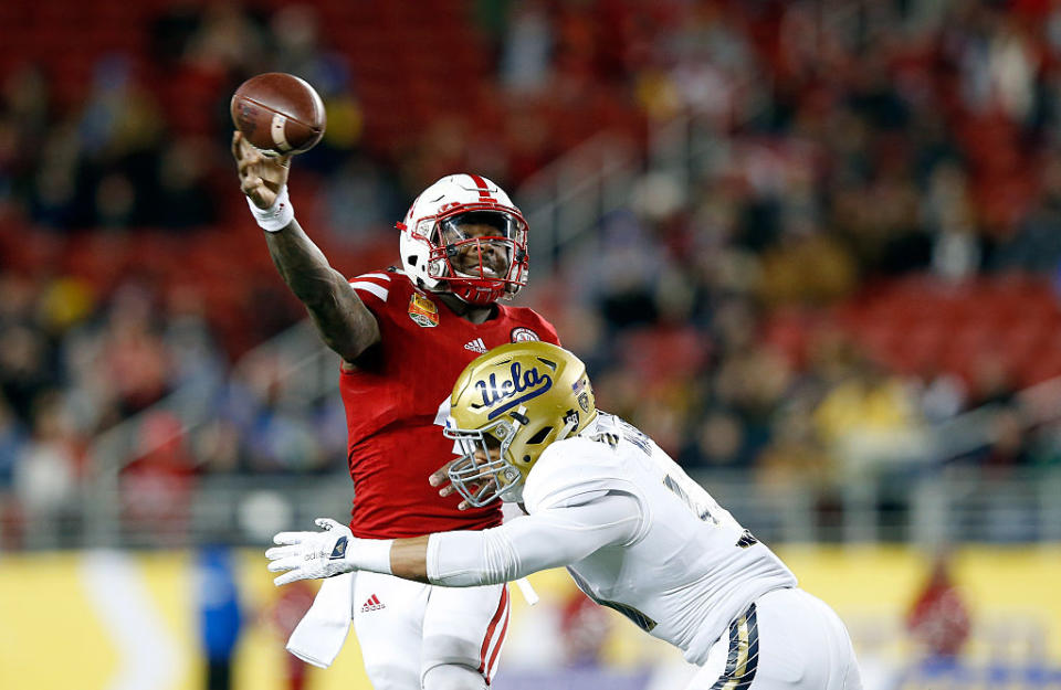 SANTA CLARA, CA - DECEMBER 26: Tommy Armstrong Jr. #4 of the Nebraska Cornhuskers is pressured by Aaron Wallace #51 of the UCLA Bruins during the Foster Farms Bowl at Levi's Stadium on December 26, 2015 in Santa Clara, California. (Photo by Ezra Shaw/Getty Images)