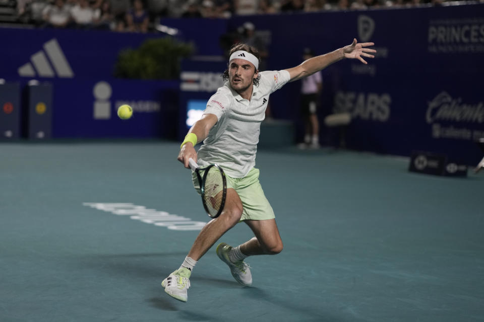 Stefanos Tsitsipas, of Greece, reaches for a shot from Flavio Cobolli, of Italy, during a Mexican Open tennis tournament match in Acapulco, Mexico, Wednesday, Feb. 28, 2024. (AP Photo/Eduardo Verdugo)