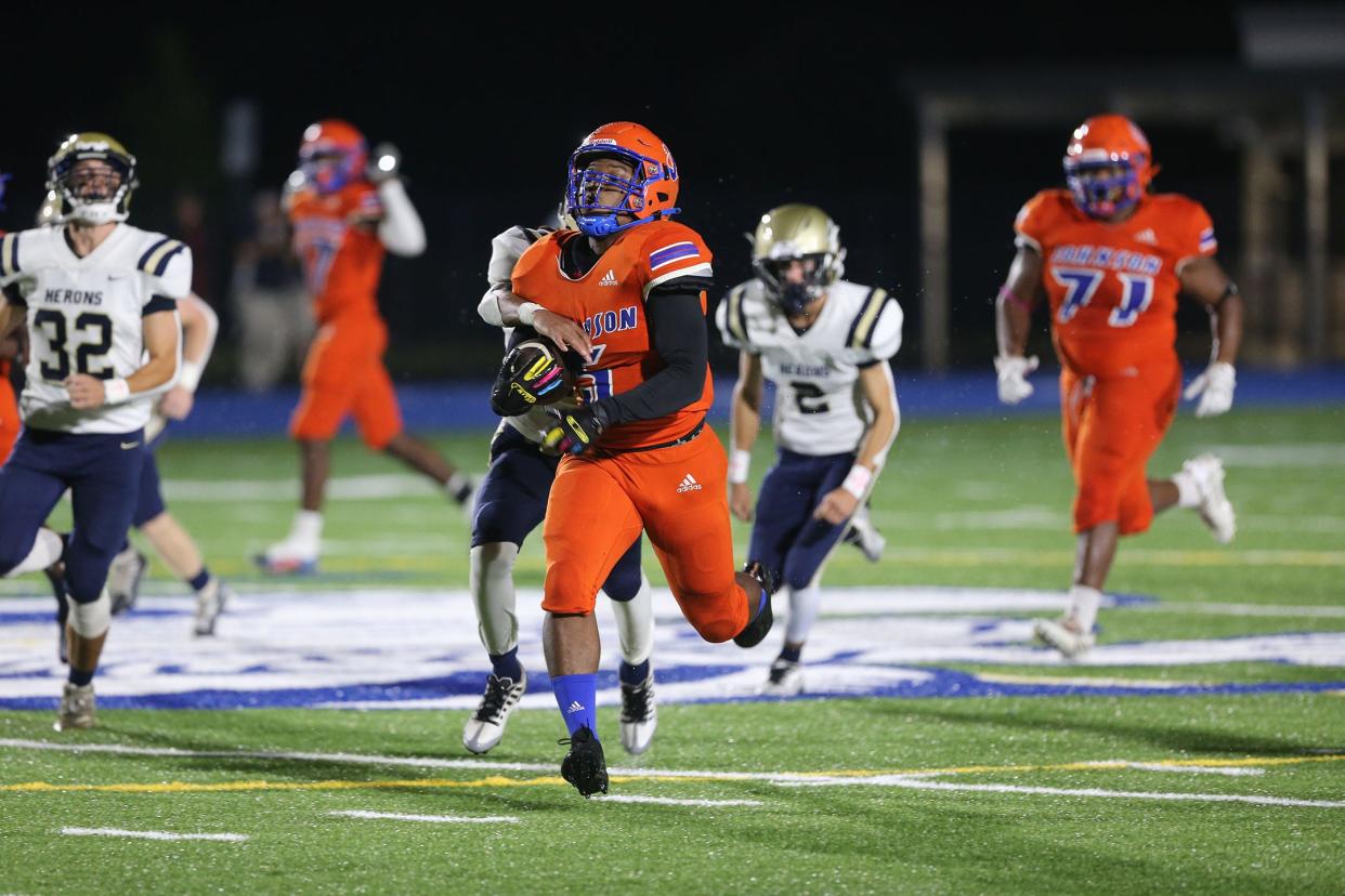 Johnson High's Amarion Scott finds some running room as Brantley County's Anthony Walker attempts ro get his hand on the ball and bring him down during Friday night's game at Savannah High School Stadium.