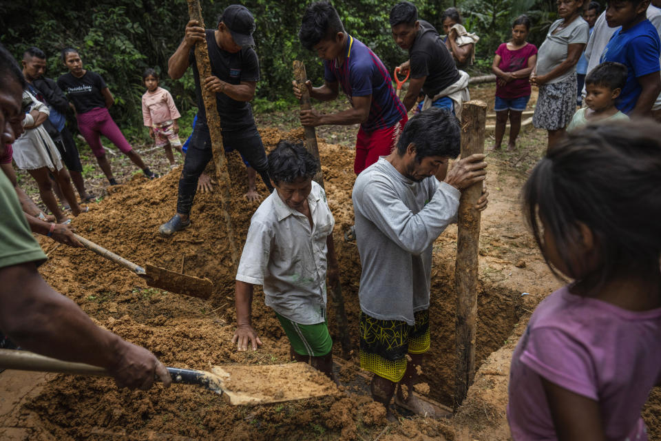 Maijunas bury the coffin that contains the remains of community member Rosario Rios, at the cemetery in Sucusari, Peru, Wednesday, May 29, 2024. A federal highway project in an untouched area of the Peruvian Amazon is facing mounting opposition from Indigenous tribes, including the Maijuna. (AP Photo/Rodrigo Abd)