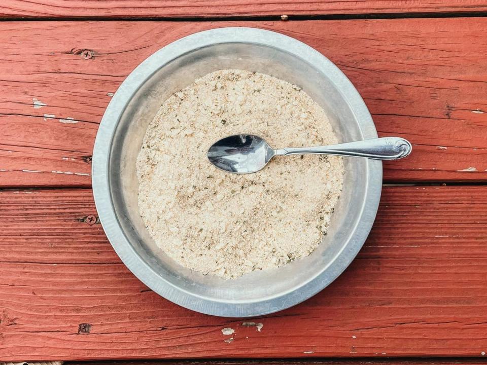 mix of parmesan cheese and panko bread crumbs in a metal bowl with a spoon in it