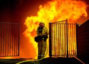 <p>A firefighter battles flames next to homes during the Holy Fire in Lake Elsinore, Calif., Aug. 9, 2018. (Photo: David McNew/EPA-EFE/REX/Shutterstock) </p>