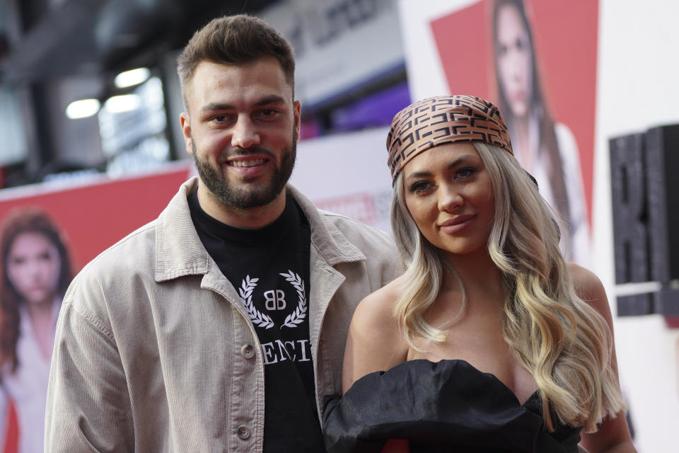 Finn Tapp, left, and Paige Turley pose for photographers upon arrival at a fan event for the film Black Widow in London, Tuesday, June 29, 2021. (AP Photo/Scott Garfitt)