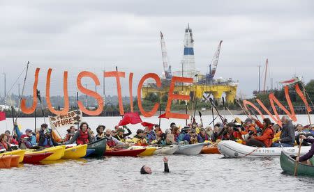 Activists protest the Shell Oil Company's drilling rig Polar Pioneer which is parked at Terminal 5 at the Port of Seattle, Washington May 16, 2015. REUTERS/Jason Redmond