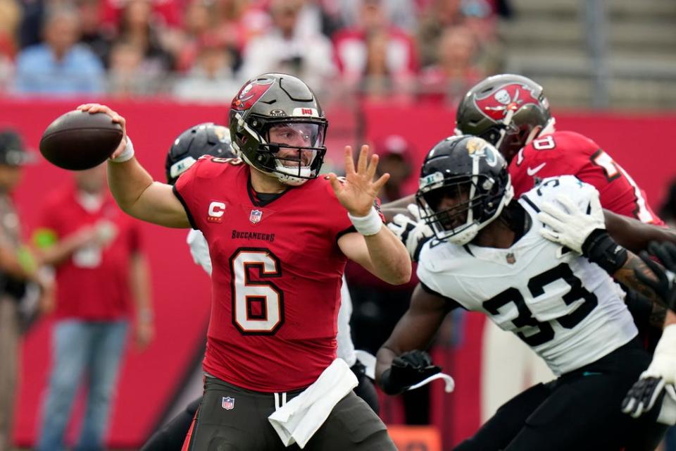 Tampa Bay Buccaneers quarterback Baker Mayfield (6) throws a pass a Jacksonville Jaguars linebacker Devin Lloyd (33) rushes during the first half of an NFL football game Sunday, Dec. 24, 2023, in Tampa, Fla. (AP Photo/Chris O'Meara)