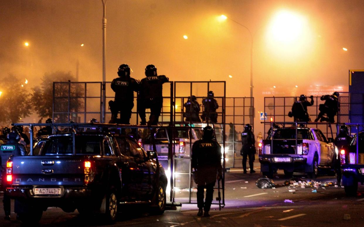 Riot police disperse protesters after polls closed in the presidential election, in Minsk  - SIARHEI LESKIEC/AFP via Getty Images