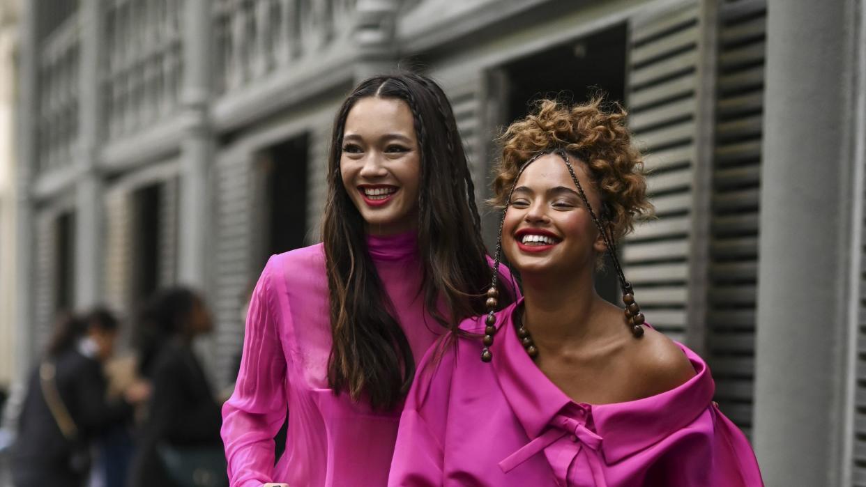 two women in pink suits