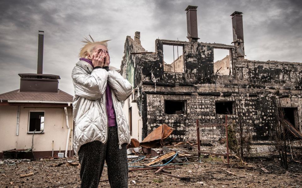 Iryna, 49, in the rubble of her village of Rus'ki Tyshky