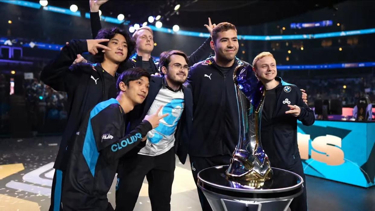 The Cloud9 team pose behind the LCS trophy