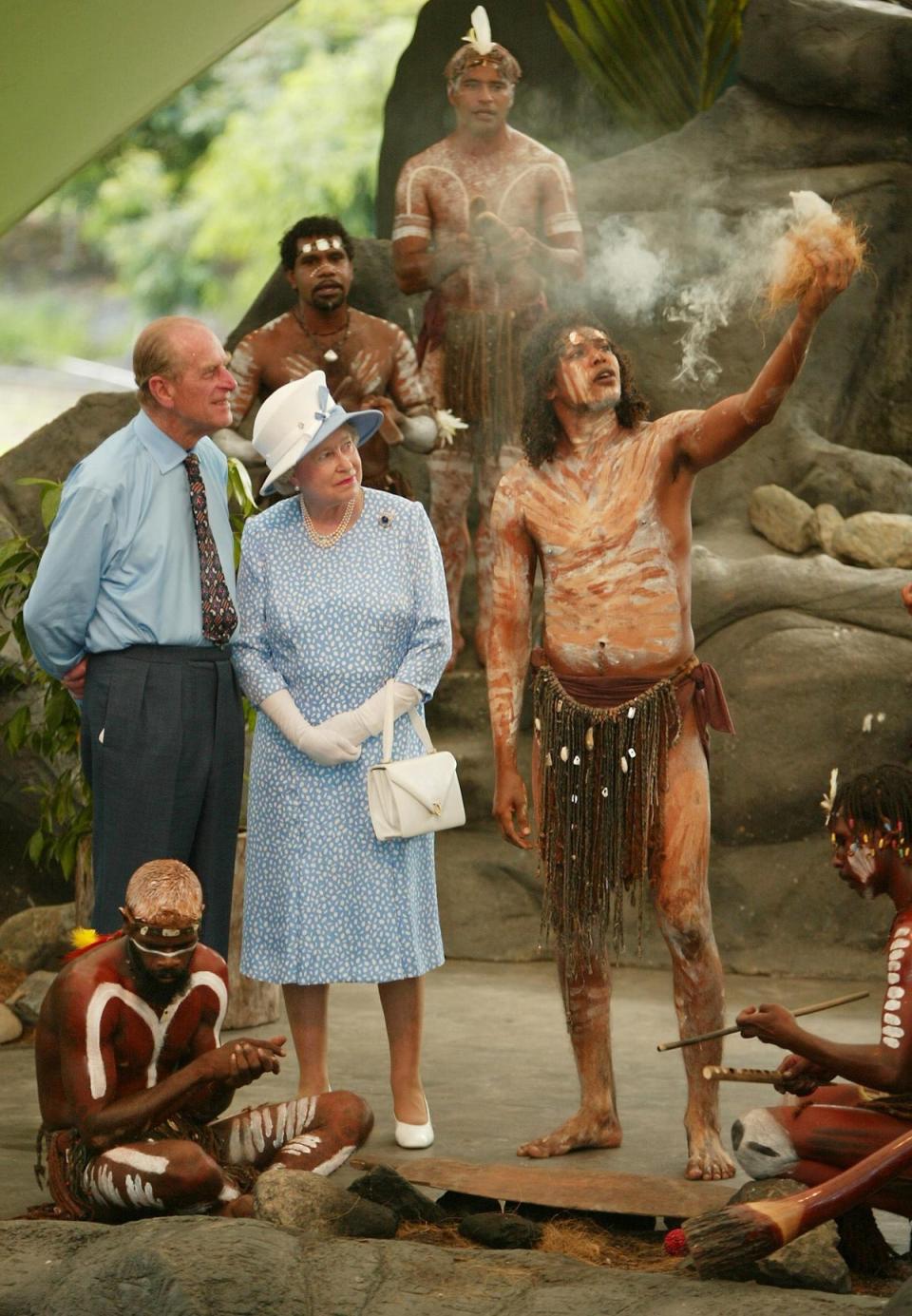 Queen Elizabeth II and Philip watch Tjapukai Aborigines light a ceremonial fire near Cairns, Australia in 2002 on the final leg of her golden jubilee tour (AFP/Getty)