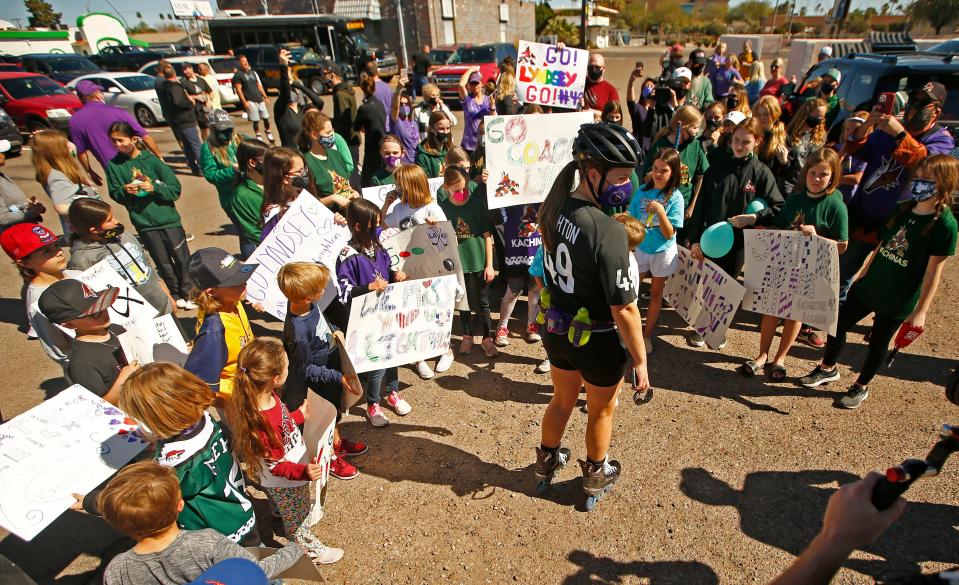 Feb. 21, 2021; Mesa, Arizona, USA; Coyotes executive Lyndsey Fry is surrounded by kids holding signs for Leighton after she skated into the Coyotes Community Ice Center parking lot during her Skatin' for Leighton fundraiser. Leighton Accardo was a local hockey fan who died at the age 9 of cancer last November.