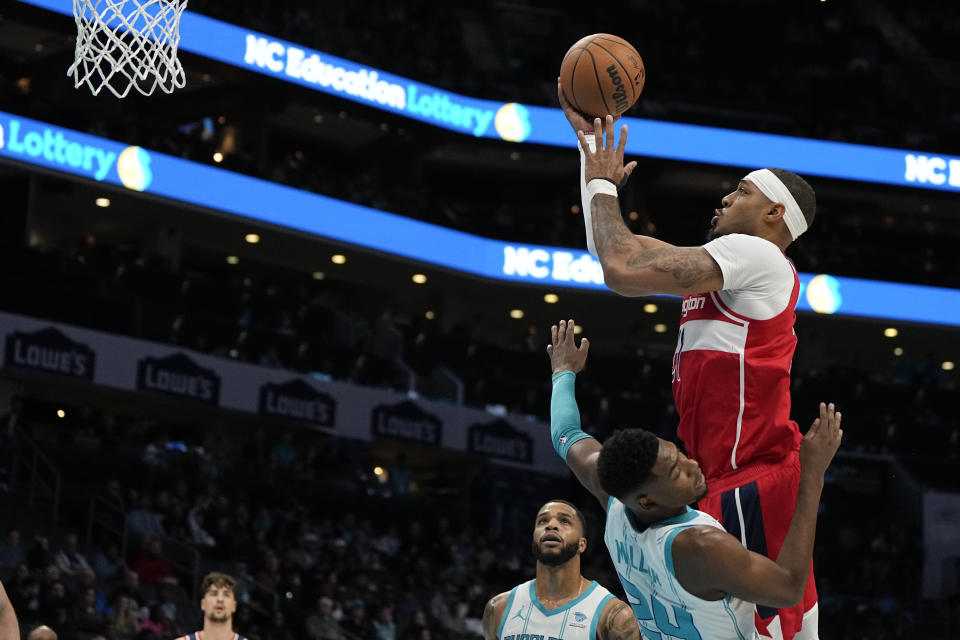 Washington Wizards center Daniel Gafford shoots over Charlotte Hornets forward Brandon Miller during the first half of an NBA basketball game on Wednesday, Nov. 22, 2023, in Charlotte, N.C. (AP Photo/Chris Carlson)