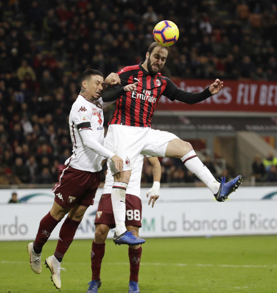 AC Milan's Gonzalo Higuain heads the ball during a Serie A soccer match between AC Milan and Torino , at the San Siro stadium in Milan, Italy, Sunday, Dec. 9, 2018. (AP Photo/Luca Bruno)