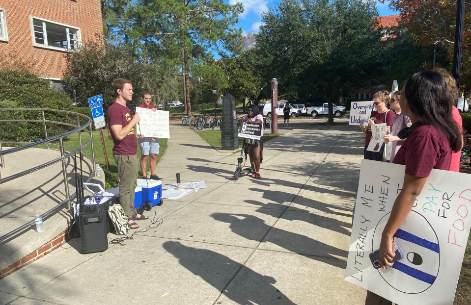 FSU's Graduate Assistants United Interim President Chandler Blount  speaks to students during the labor union's rally in front of Strozier Library on Tuesday, December 6, 2022.