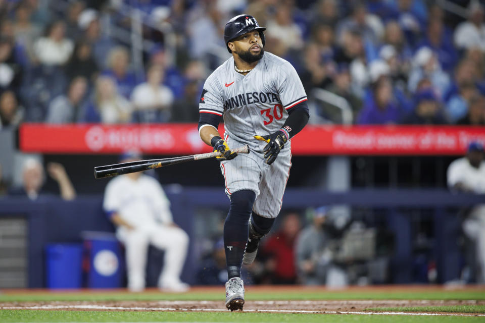 Minnesota Twins' Carlos Santana (30) watches his solo home run against the Toronto Blue Jays during the fifth inning of a baseball game Friday, May 10, 2024, in Toronto. (Cole Burtson/The Canadian Press via AP)