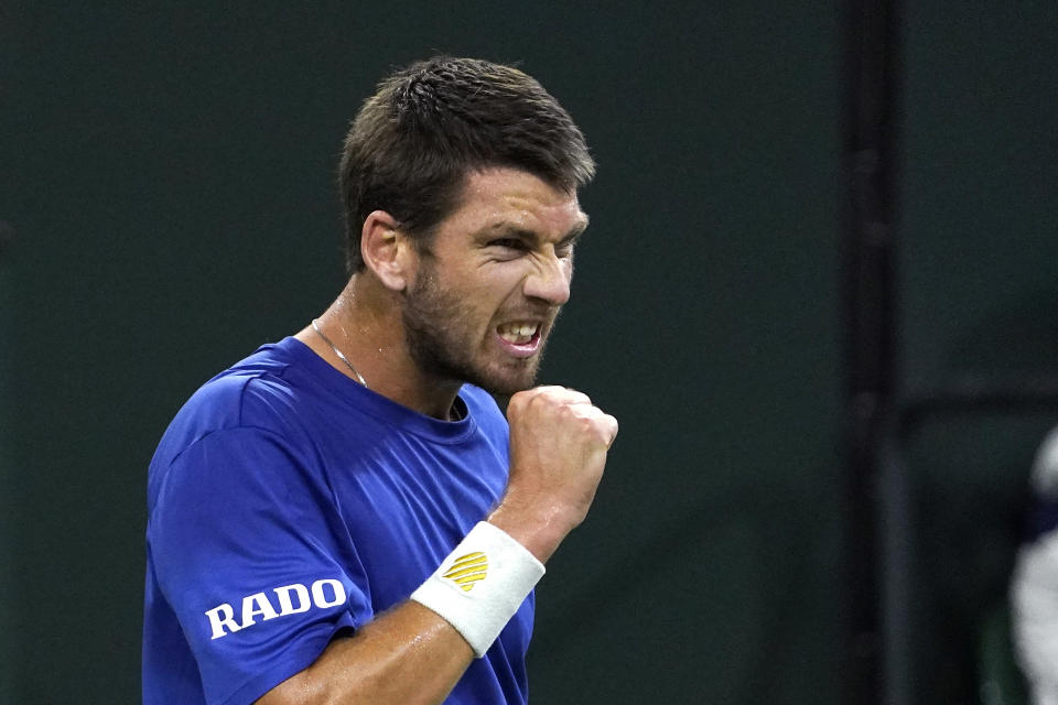 Cameron Norrie, of Britain, reacts to winning a game against Nikoloz Basilashvili, of Georgia, in the singles final at the BNP Paribas Open tennis tournament Sunday, Oct. 17, 2021, in Indian Wells, Calif. (AP Photo/Mark J. Terrill)