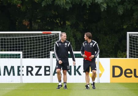 Germany national goalkeeper coach Andreas Koepke and assistant coach Thomas Schneider (R) chat during a training session in Frankfurt, Germany, October 6, 2015. REUTERS/Ralph Orlowski