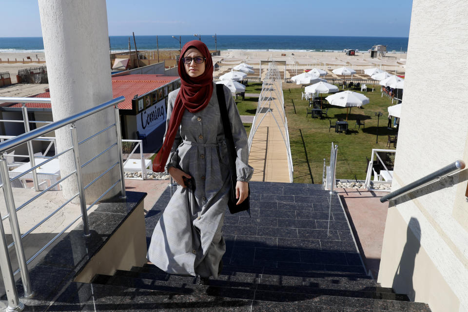 Palestinian student Afaf al-Najar, walks at the sea side beach restaurant in Gaza City, Wednesday, Nov. 3, 2021. Al-Najar is fighting to travel out of the Palestinian enclave to Turkey, where he has won a scholarship, but her father banned her, taking advantage of a new Hamas ruling that bars women from traveling against the well of their male "guardians.". (AP Photo/Adel Hana)