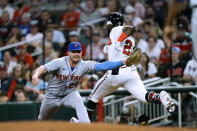 Atlanta Braves' Michael Harris II (23) is put out at first base by New York Mets first baseman Pete Alonso (20) on a ground ball during the fourth inning of a baseball game Monday, Aug. 15, 2022, in Atlanta. (AP Photo/John Bazemore)