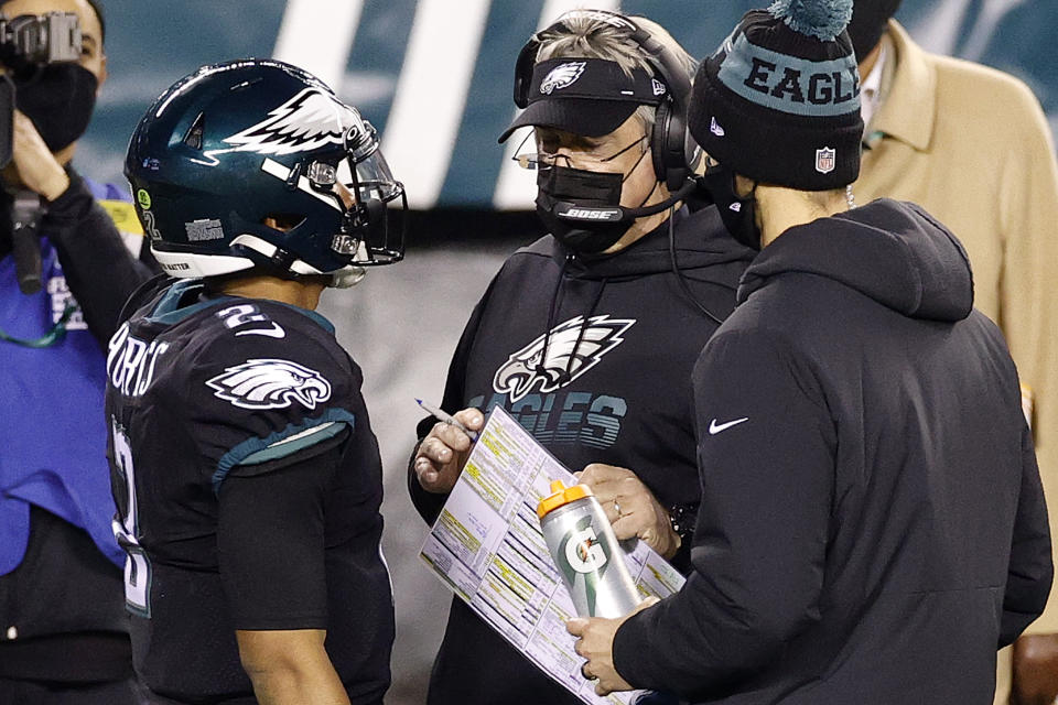 PHILADELPHIA, PENNSYLVANIA - DECEMBER 13: Philadelphia Eagles head coach Doug Pederson speaks with Jalen Hurts #2 of against the New Orleans Saints at Lincoln Financial Field on December 13, 2020 in Philadelphia, Pennsylvania. (Photo by Tim Nwachukwu/Getty Images)