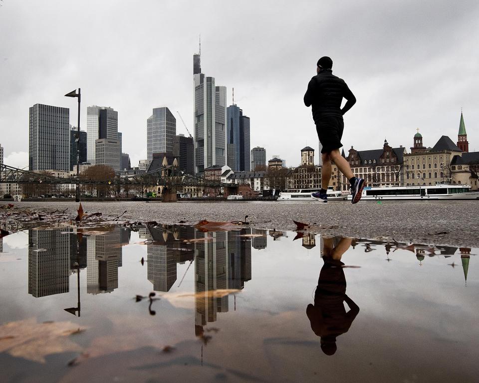 <p>A man is mirrored in a puddle as he jogs along the river Main in Frankfurt, Germany, Thursday, Jan. 17, 2019. (AP Photo/Michael Probst) </p>
