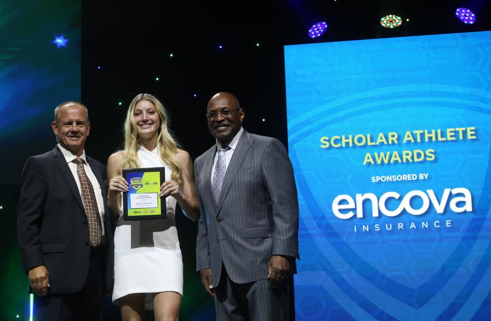 Bexley's Grace Heilman receives the Female Scholar Athlete of the Year award from John Kessler, Encova Insurance executive vice president and chief strategy officer, and Archie Griffin, two-time Heisman Trophy winner and Encova Insurance representative.