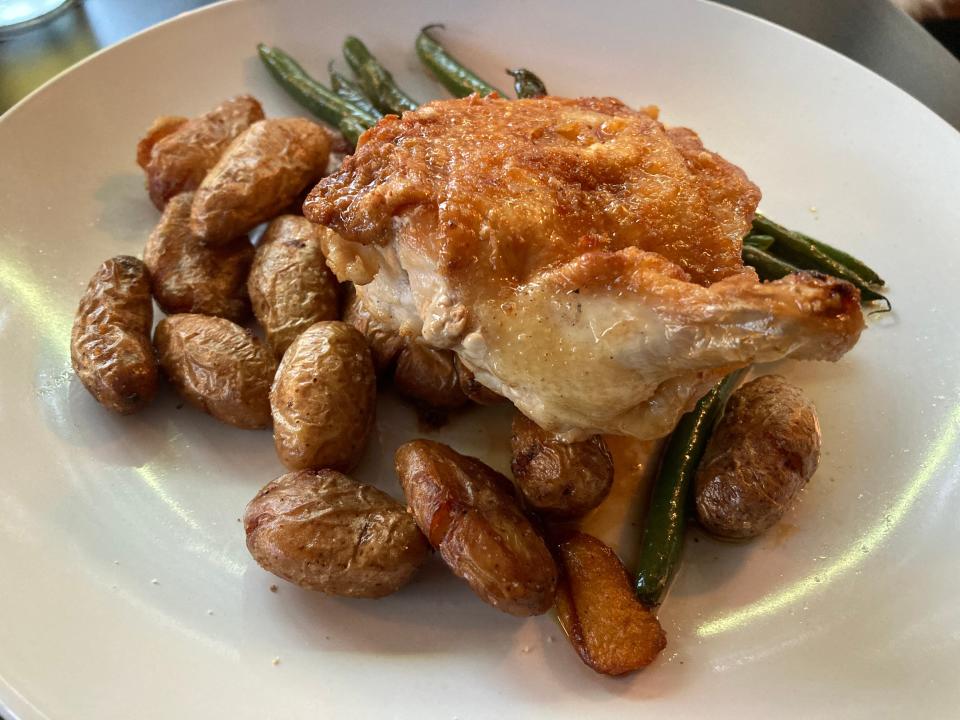 Chicken breast with crispy potatoes and pan-roasted green beans at Madbush Falls in Waitsfield on Aug. 17, 2023.