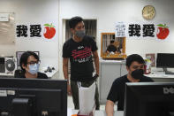 Staff members design their layout for the last edition of the newspaper at the Apple Daily headquarters in Hong Kong, Wednesday, June 23, 2021. Hong Kong's pro-democracy Apple Daily newspaper will stop publishing Thursday, following last week's arrest of five editors and executives and the freezing of $2.3 million in assets under the city's year-old national security law. (AP Photo/Kin Cheung)