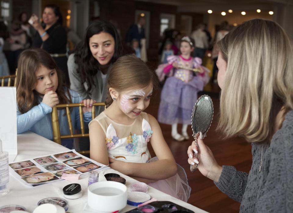 Grace Rojee - then 7 - admires her face paint at the Newport Winter Festival "Princess Party" held at Oceancliff in 2020.