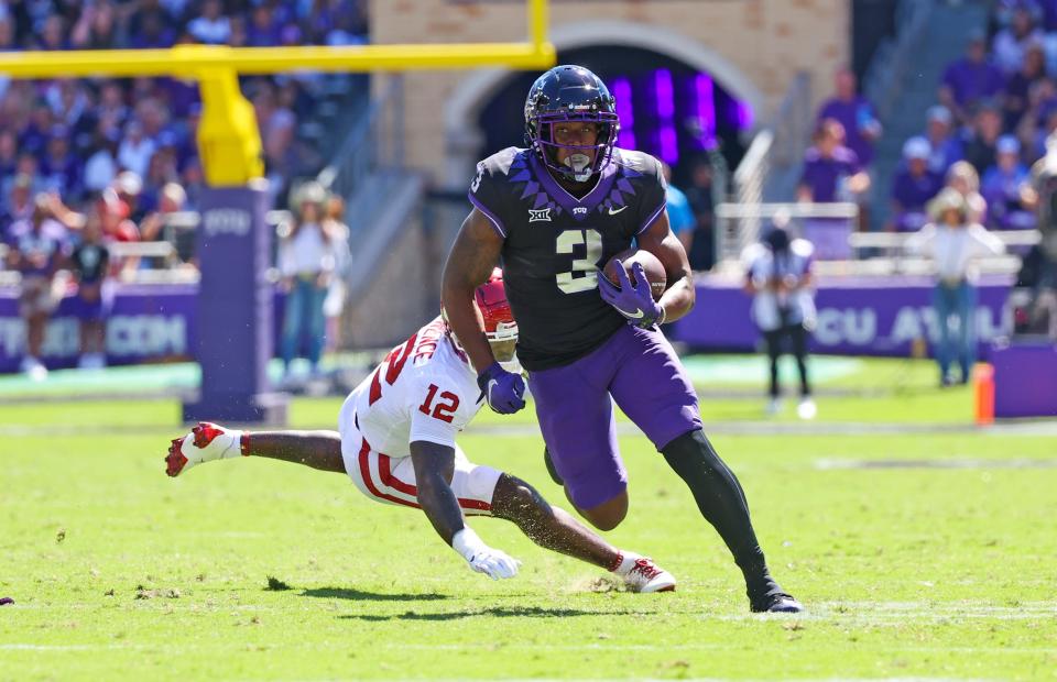 TCU running back Emari Demercado runs with the ball past Oklahoma Sooners defensive back Key Lawrence during the first half at Amon G. Carter Stadium.