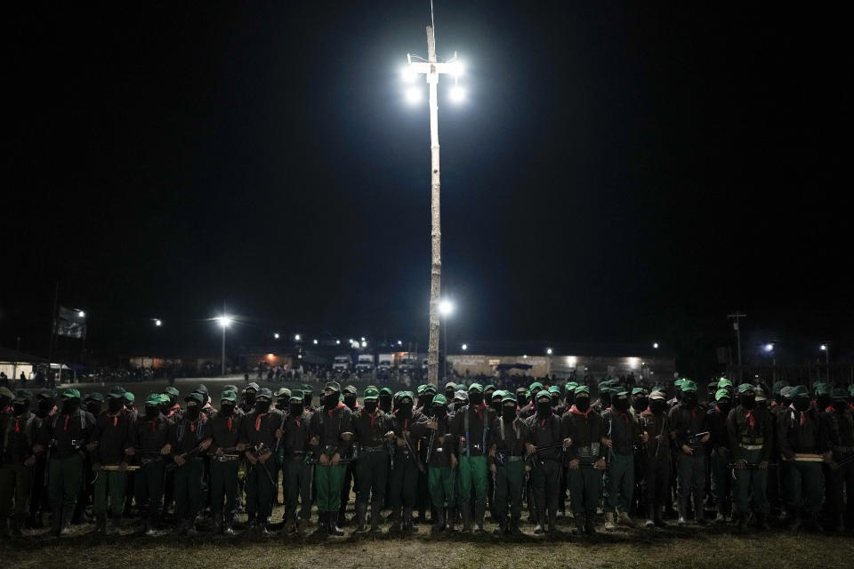 Members of the Zapatista National Liberation Army, EZLN, attend an event marking the 30th anniversary of the Zapatista uprising in Dolores Hidalgo, Chiapas, Mexico, Sunday, Dec. 31, 2023. (AP Photo/Eduardo Verdugo)