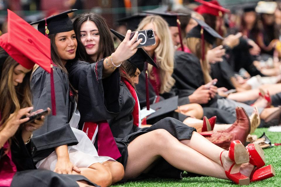 Kendall Terich, left, and Lexie Bataan take a selfie before their University of Alabama Commencement at Coleman Coliseum on the UA campus in Tuscaloosa, Ala., on Fiday May 3, 2024.