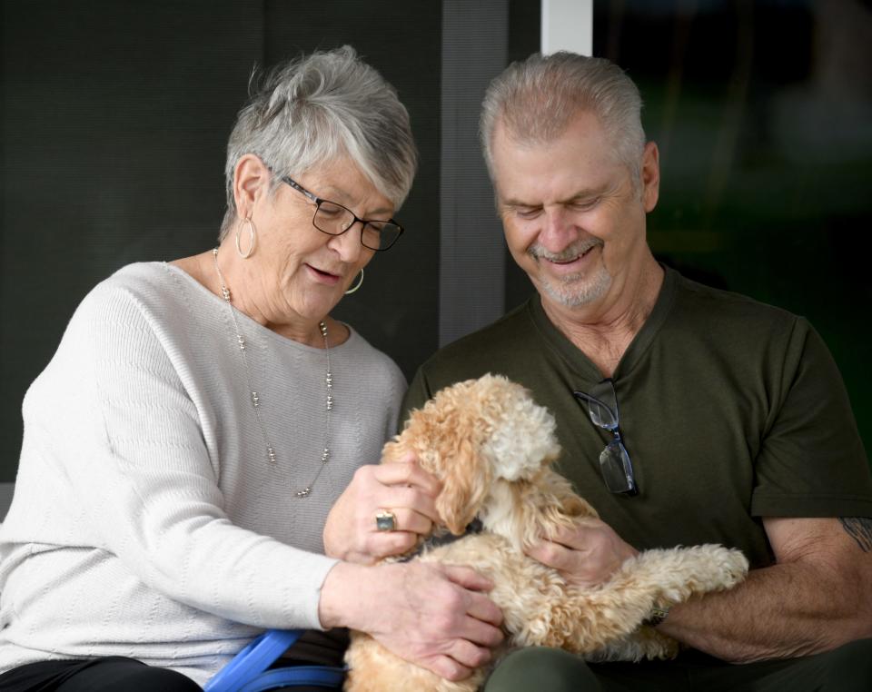 Barb and George Jasinski of Massillon with their new dog, a goldendoodle named Sadie. They said they got Sadie only after they spent $1,400 on two dachshund puppies but never received them from a breeder in Beloit.