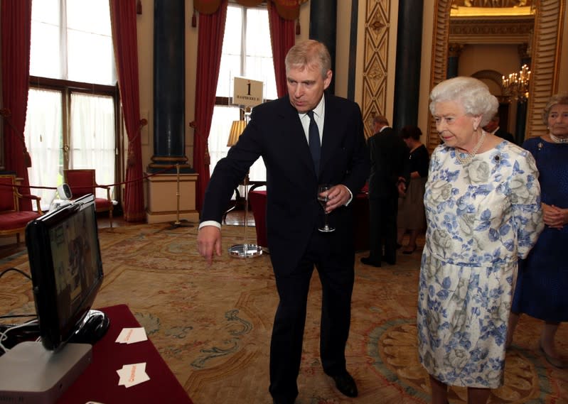FILE PHOTO: Britain's Queen Elizabeth and Prince Andrew speak with Maynard via the internet on a Nominet Trust display screen in London