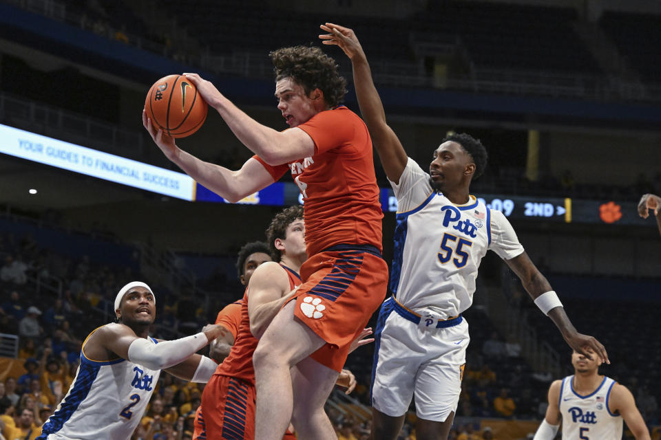Clemson forward Ian Schieffelin pulls down a rebound as Pittsburgh forward Zack Austin (55) looks on during the second half of an NCAA college basketball game, Sunday, Dec. 3, 2023, in Pittsburgh, Pa. (AP Photo/Barry Reeger)