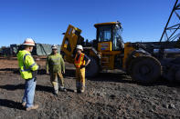 Workers talk at the Energy Fuels Inc. uranium Pinyon Plain Mine Wednesday, Jan. 31, 2024, near Tusayan, Ariz. The largest uranium producer in the United States is ramping up work just south of Grand Canyon National Park on a long-contested project that largely has sat dormant since the 1980s. (AP Photo/Ross D. Franklin)