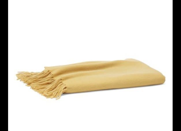 Solid cashmere throw in marigold, $249, from <a href="http://www.williams-sonoma.com/products/solid-cashmere-throw/?pkey=e|throw|2|best|0|1|24||1&cm_src=PRODUCTSEARCH||NoFacet-_-NoFacet-_-NoMerchRules-_-" target="_hplink">Williams-Sonoma Home</a>. 