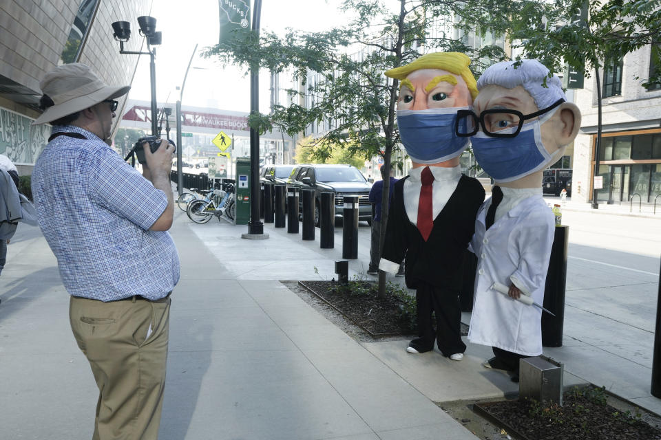 People arrive before a Republican presidential primary debate sponsored by FOX News Channel Wednesday, Aug. 23, 2023, in Milwaukee. (AP Photo/Morry Gash)