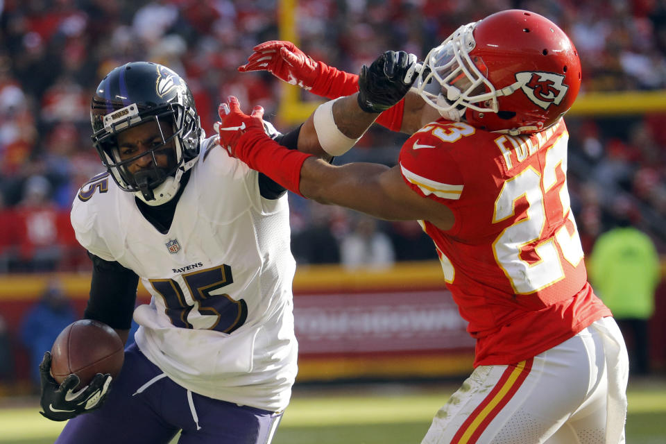 Baltimore Ravens wide receiver Michael Crabtree (15) tries to get past Kansas City Chiefs cornerback Kendall Fuller (23) during the second half of an NFL football game in Kansas City, Mo., Sunday, Dec. 9, 2018. (AP Photo/Charlie Riedel)