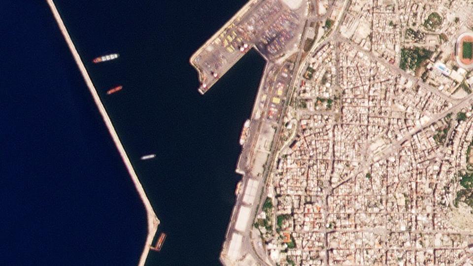 This satellite image from Planet Labs PBC shows the Russian-flagged ship Matros Pozynich, center, inside the harbor of Latakia, Syria, Tuesday, May 10, 2022. Satellite photos analyzed by The Associated Press on Wednesday showed the Russian ship believed to be carrying stolen Ukrainian grain in Latakia, Syria. (Planet Labs PBC via AP)