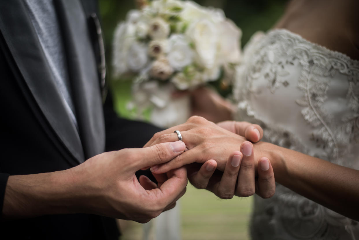 Close up of groom wears the ring bride in wedding day. Love, happy marry concept.