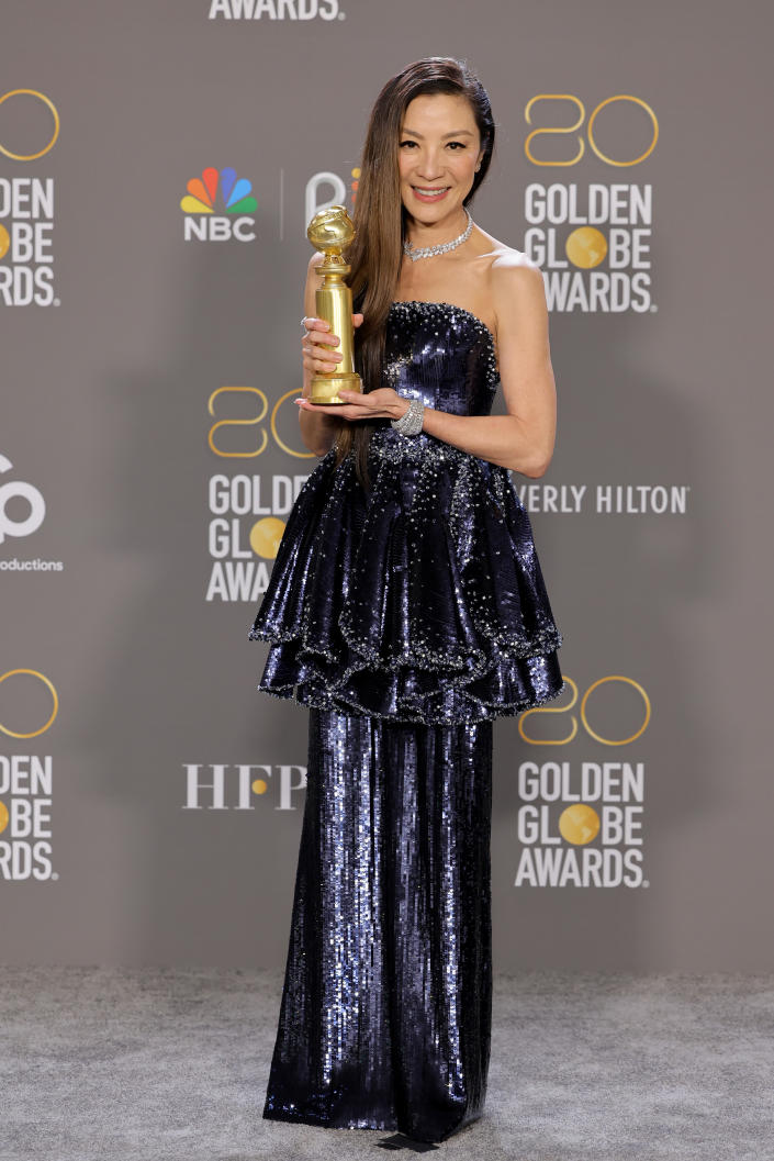 Michelle Yeoh poses with the Best Actress in a Motion Picture award at the Golden Globe Awards, 2023