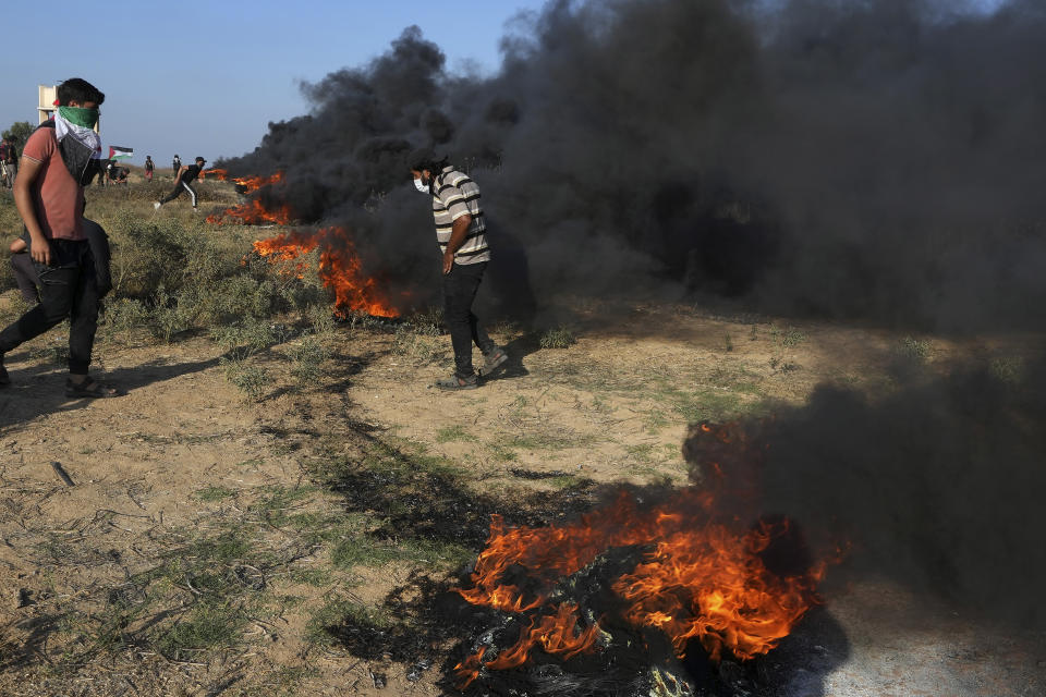 Palestinian protesters burn tires during clashes with Israeli security forces along the frontier with Israel, east of Gaza City, Friday, Sept. 22, 2023. The Israeli military said it struck three posts belonging to Hamas, the Islamic militant group that has controlled Gaza since 2007, following a number of incendiary balloons launched from Gaza into Israel. This is the latest violence to roil the territory as Palestinians stage routine protests by the border fence. (AP Photo/Adel Hana)