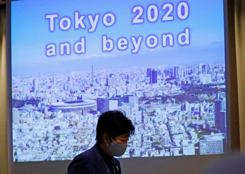 Tokyo Governor Yuriko Koike, wearing a protective face mask, arrives for a news conference, amid the coronavirus disease (COVID-19) outbreak, in Tokyo