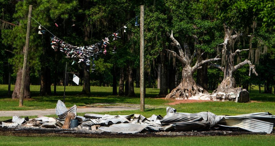 One of the remaining movie prop houses from the Town of Spectre scenes in the film Big Fish burned after being struck by lightning on Jackson Island in Millbrook, Ala., as seen on Monday July 3, 2023.