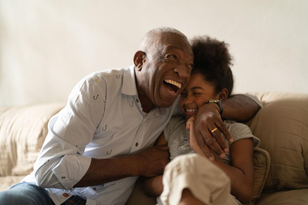 grandfather playing with her granddaughter at home