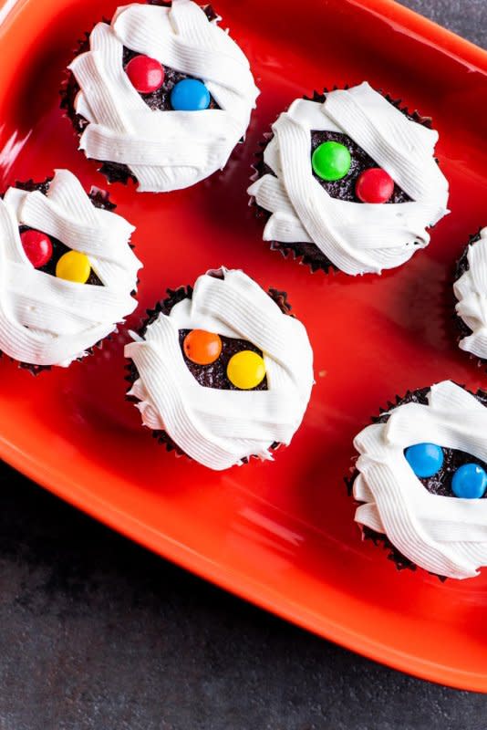 <p>Katie Workman</p><p>These adorable cupcakes don’t take much more time to make than a regular batch, but a few extra moments for the frosting makes them terrifically terrifying.</p><p><strong>Get the recipe: <a href="https://parade.com/842775/katieworkman/how-to-make-the-cutest-and-easiest-mummy-cupcakes-for-halloween/" rel="nofollow noopener" target="_blank" data-ylk="slk:Mummy Cupcakes;elm:context_link;itc:0;sec:content-canvas" class="link ">Mummy Cupcakes</a></strong></p>