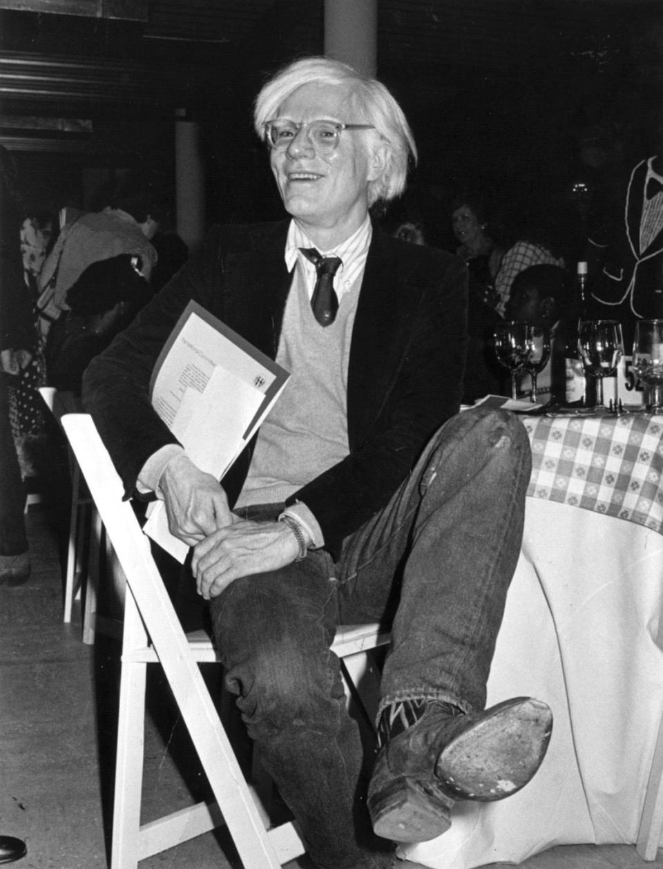 artist andy warhol in cowboy boots at fundraiser, 1979